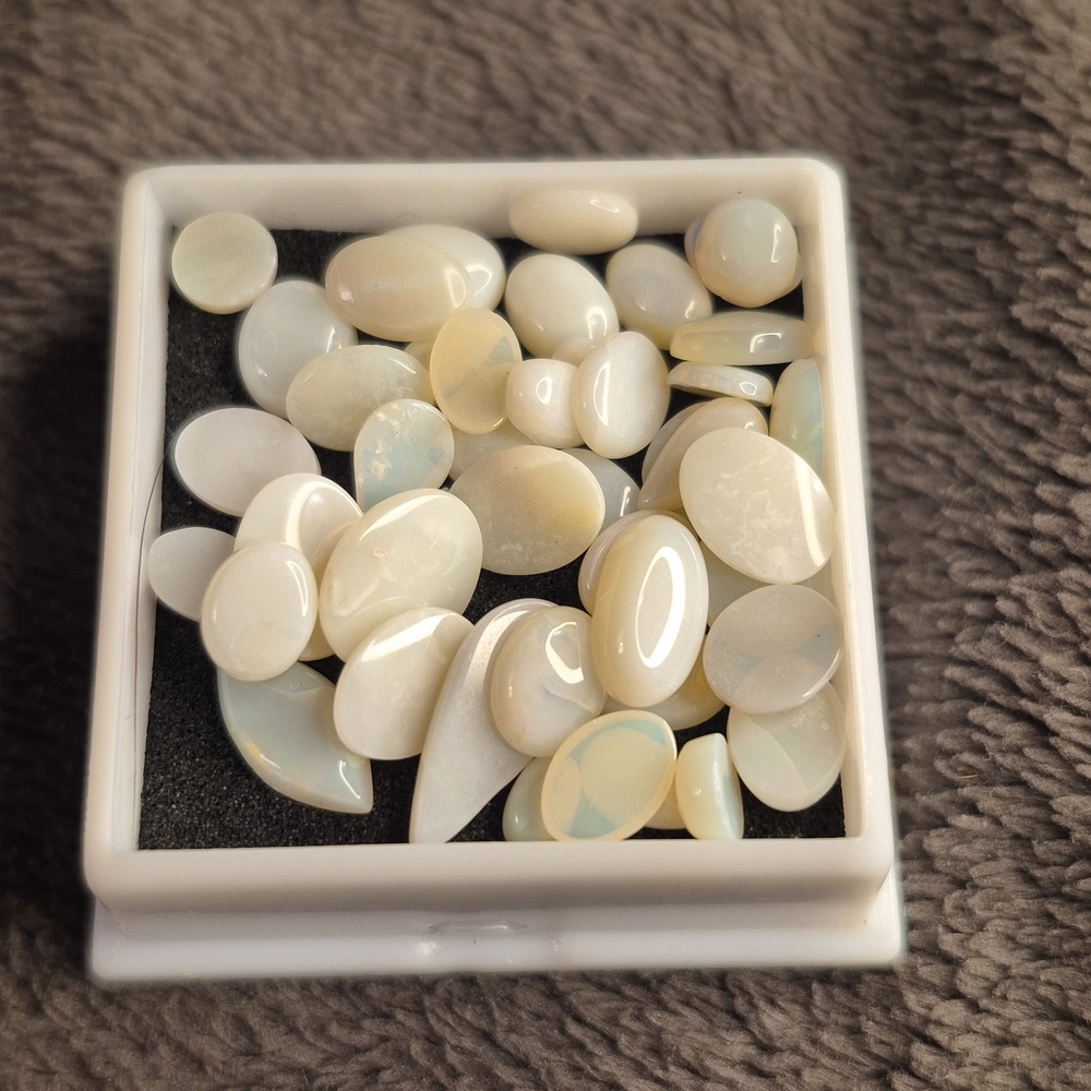 Opals 20+ carats by weight varied shapes and sizes up to approx 6mm